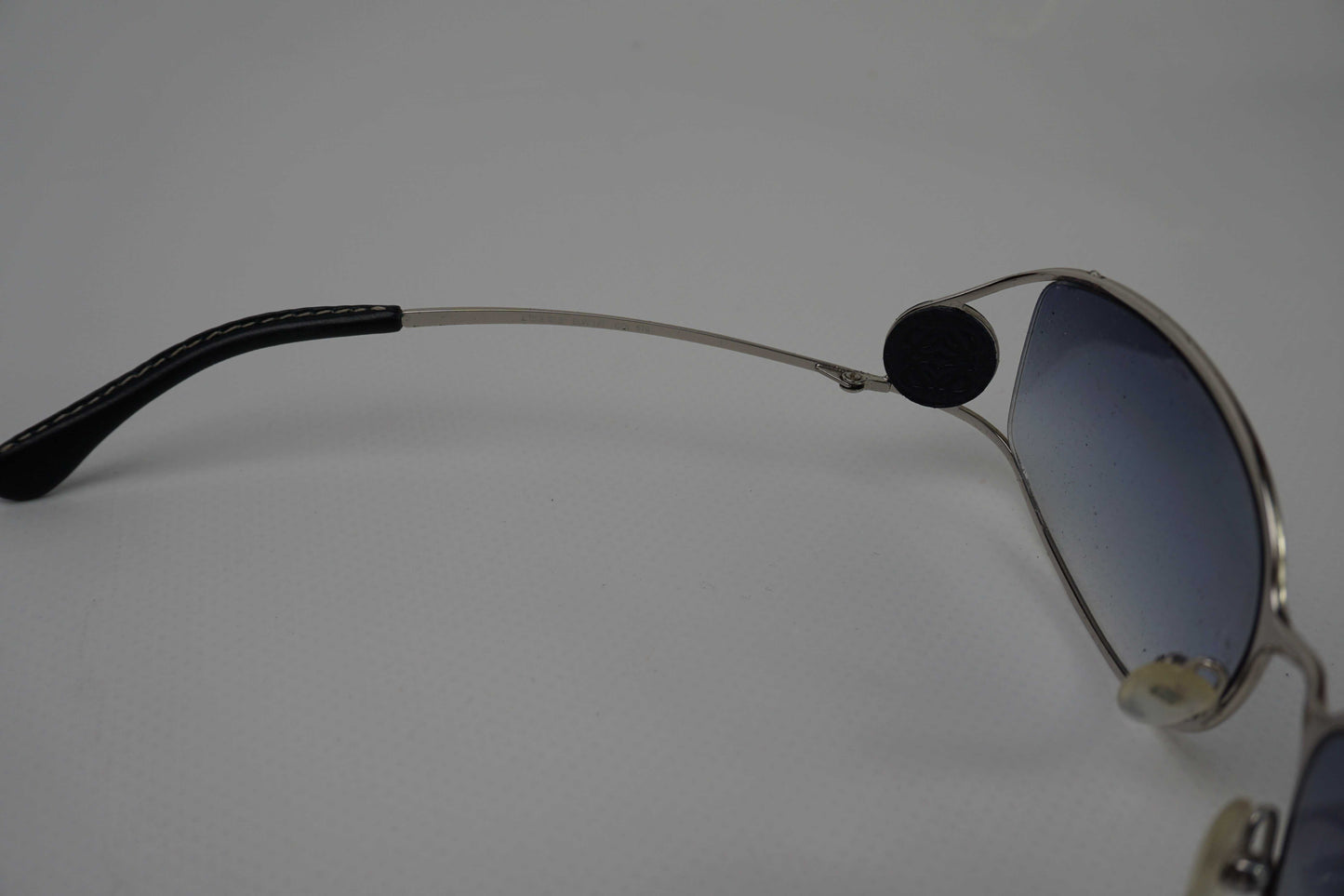 LOEWE Shades Blue sunglasses with blue lenses and sleek metal frame.