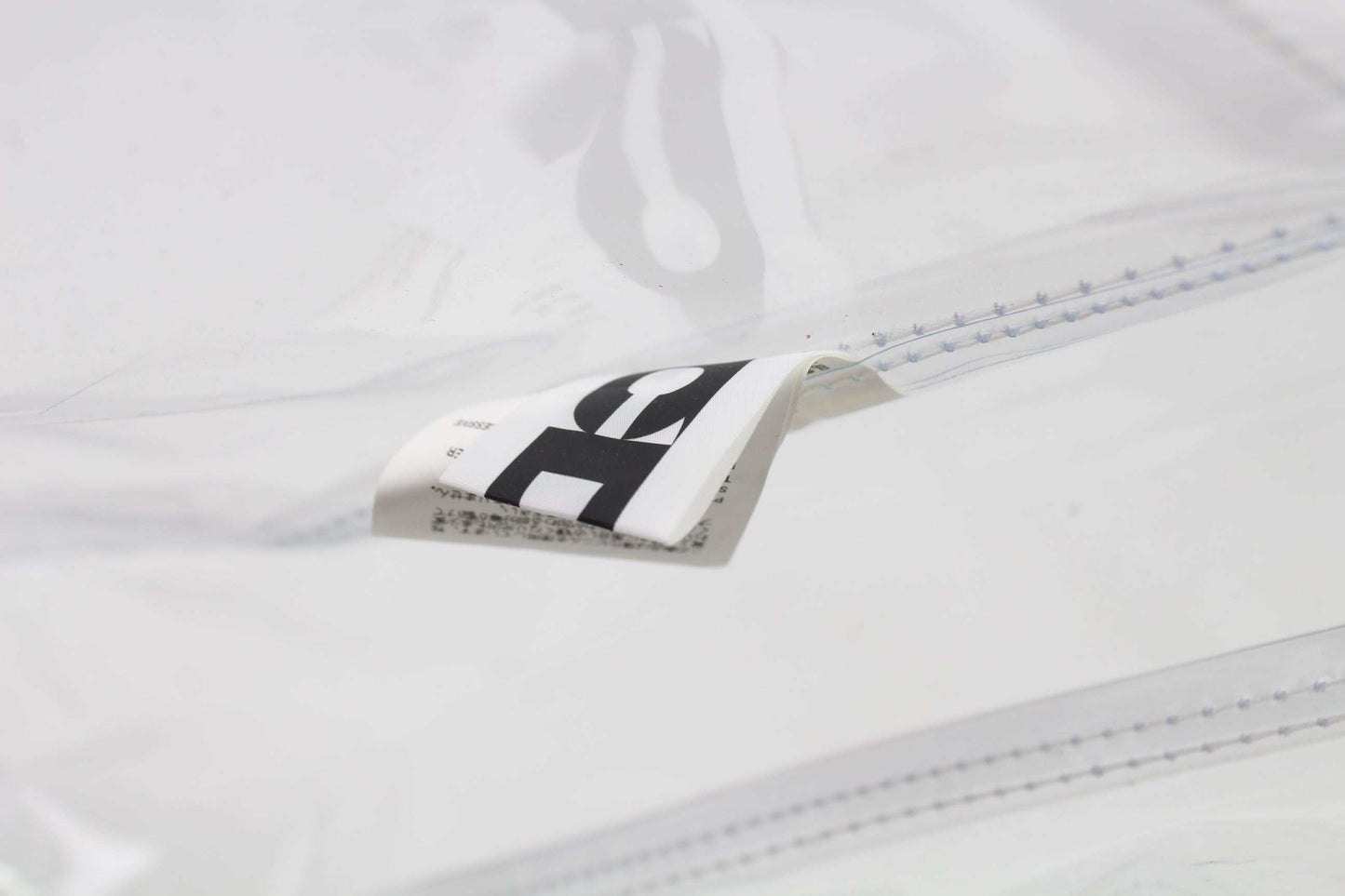 COMME DES GARCONS Shopper Clear plastic bag showcasing slight wear.