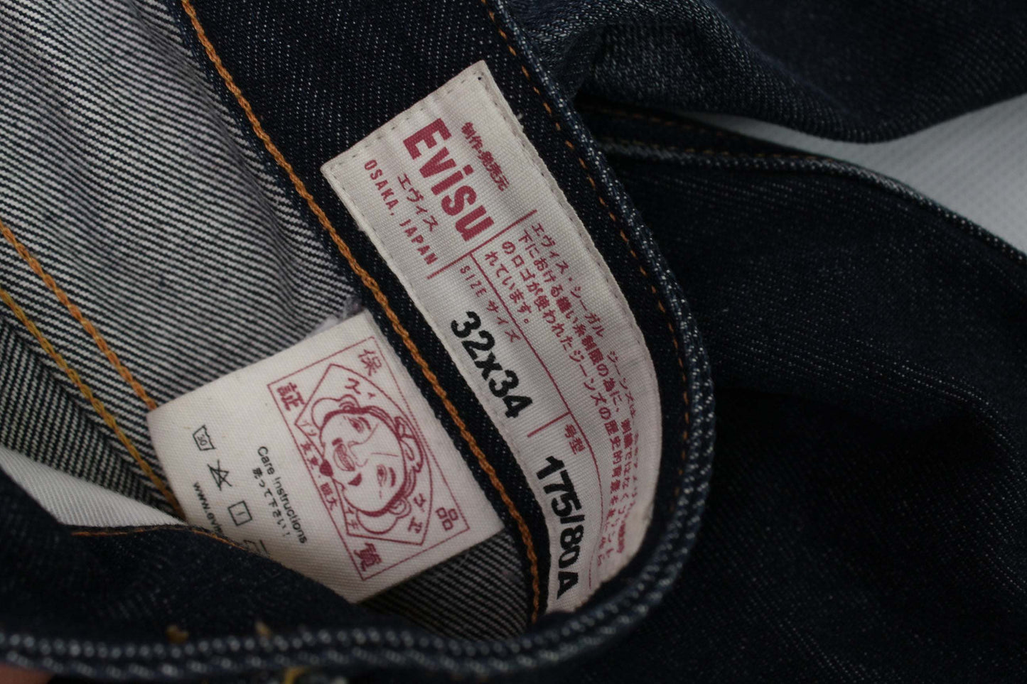 EVISU Blue Daicock Denim Selvedge jeans tag, size 32x34, dark blue, 100% cotton.