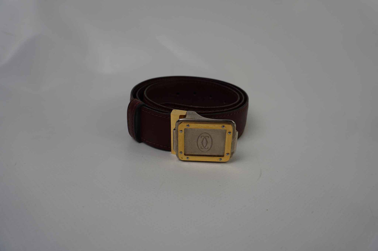 CARTIER Bordeaux leather belt with interchangeable gold and silver buckle, 95cm, wine red color.