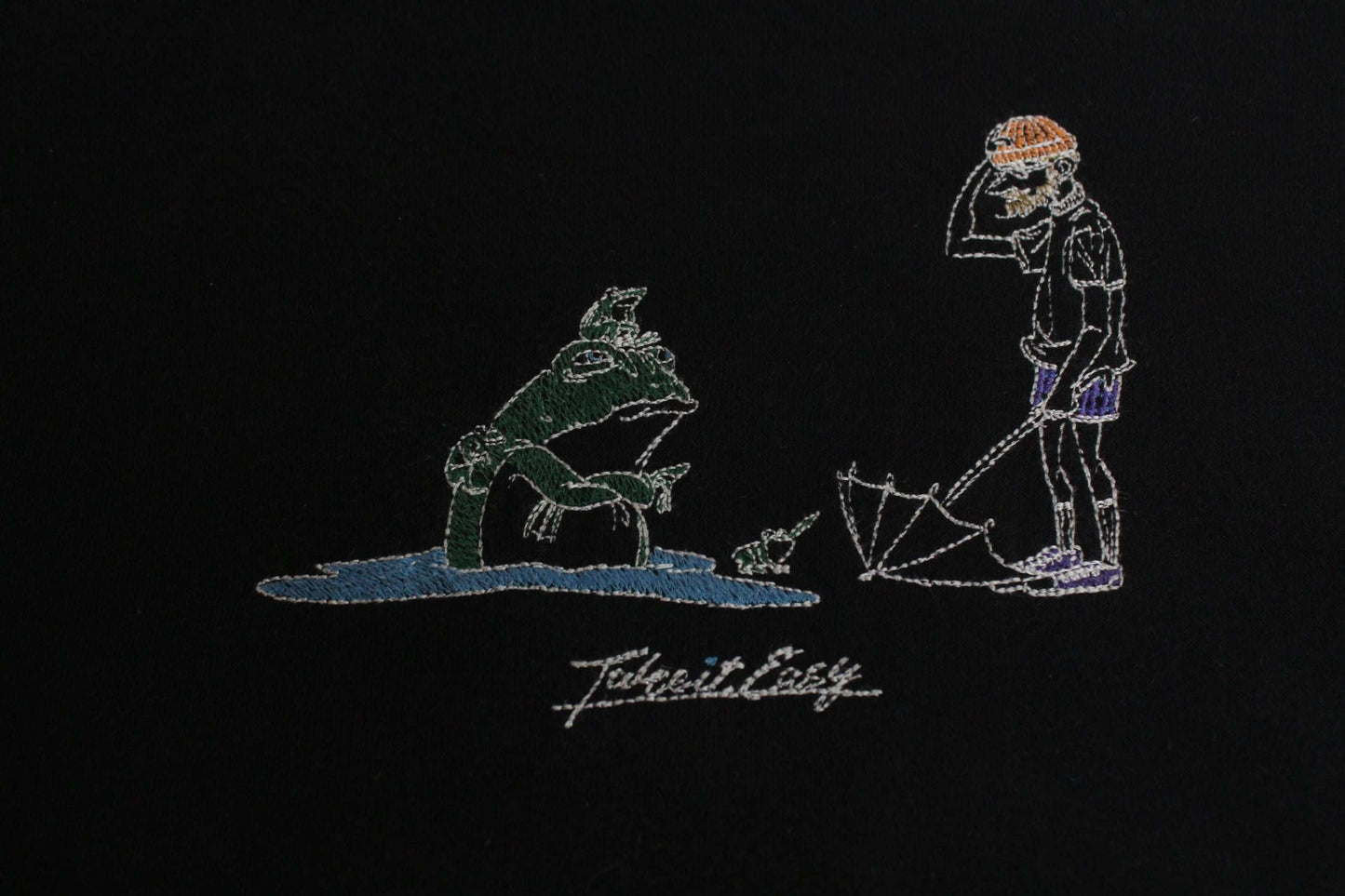 Black LEFT ALONE hoodie design detail featuring artwork with a person and creature.