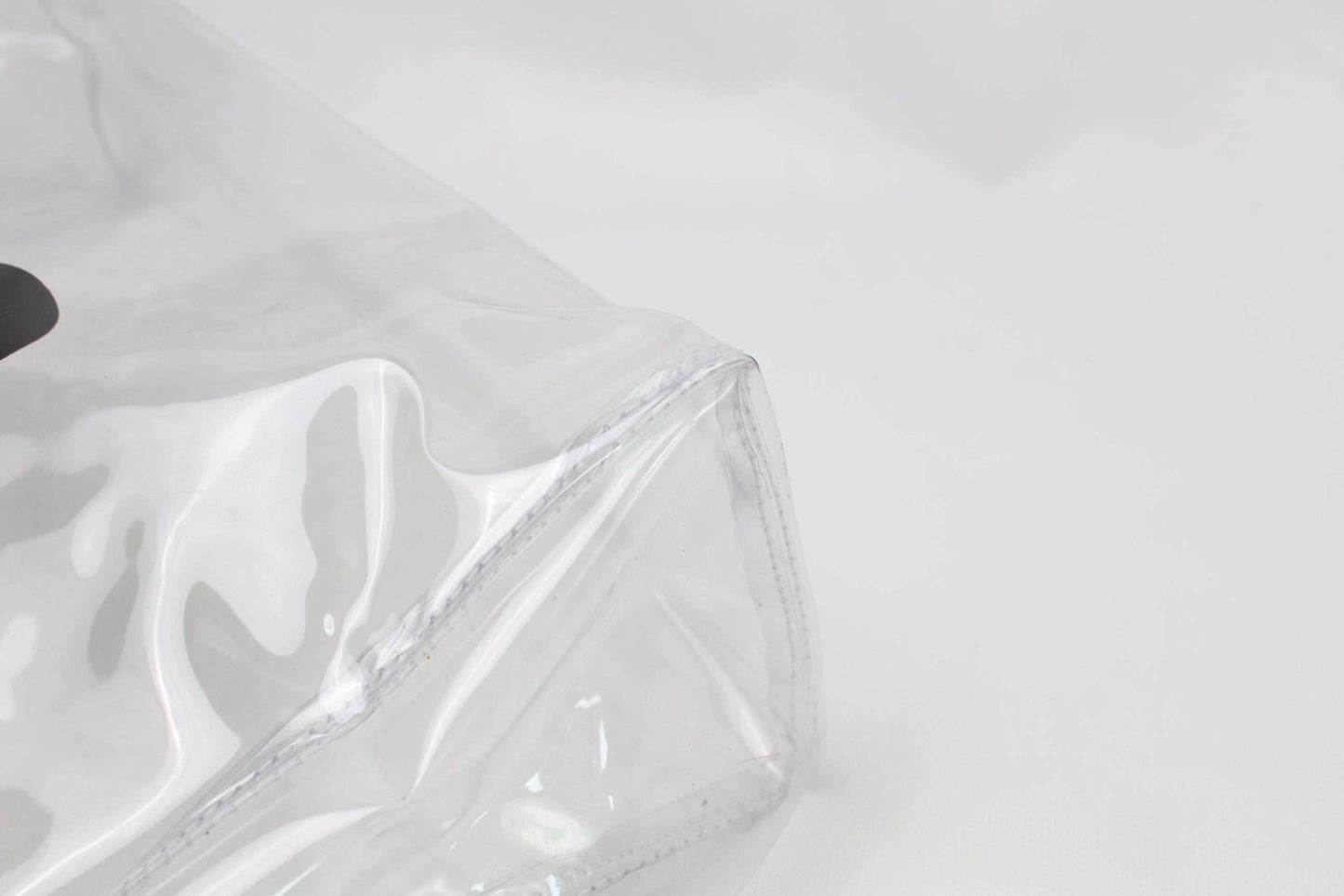 Clear plastic Comme des Garcons shopper bag with minor wear.
