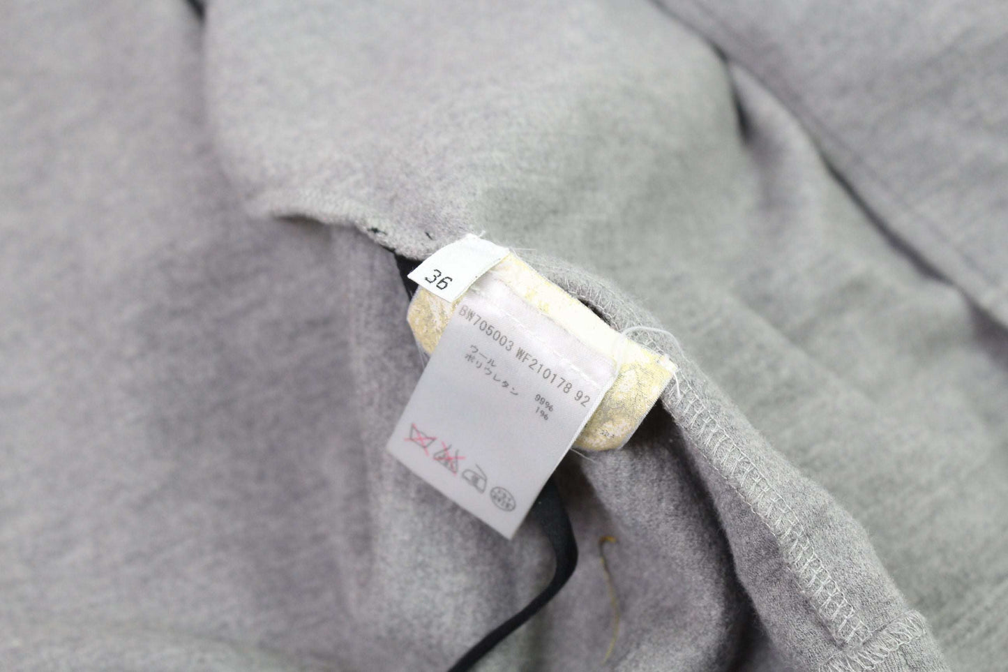 JIL SANDER grey wool cardigan, size 36, showing fabric tag.