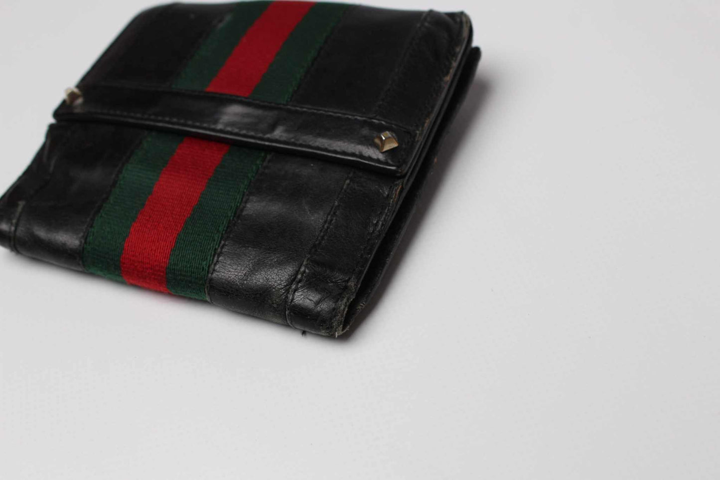 GUCCI wallet in black leather with red and green stripe design.