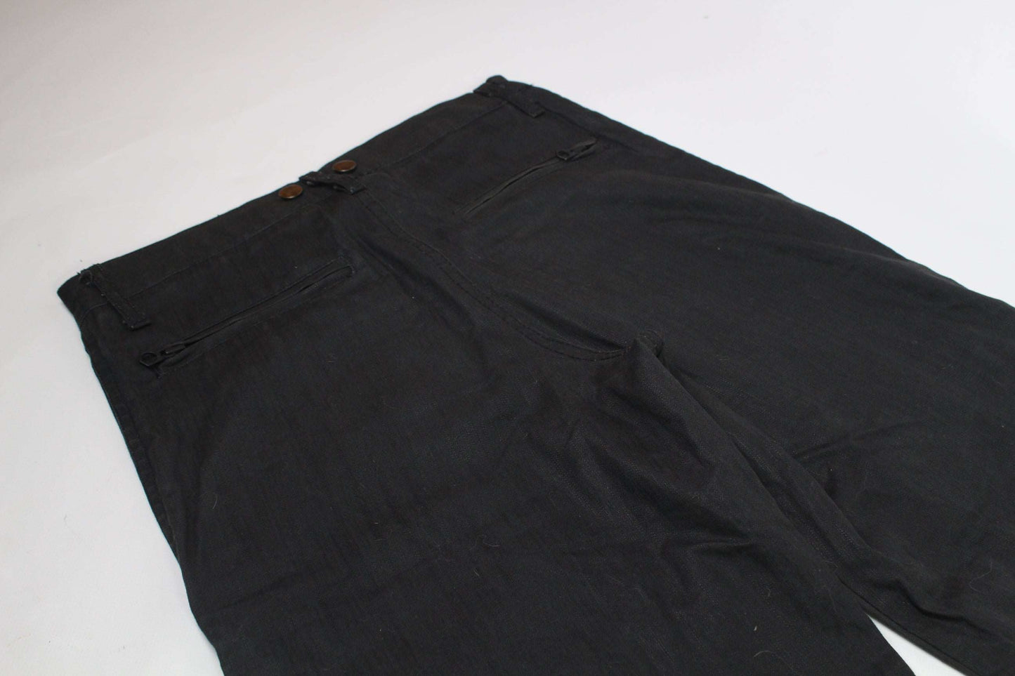 Baggy black FUGA pants in size 32, waxed cotton material.