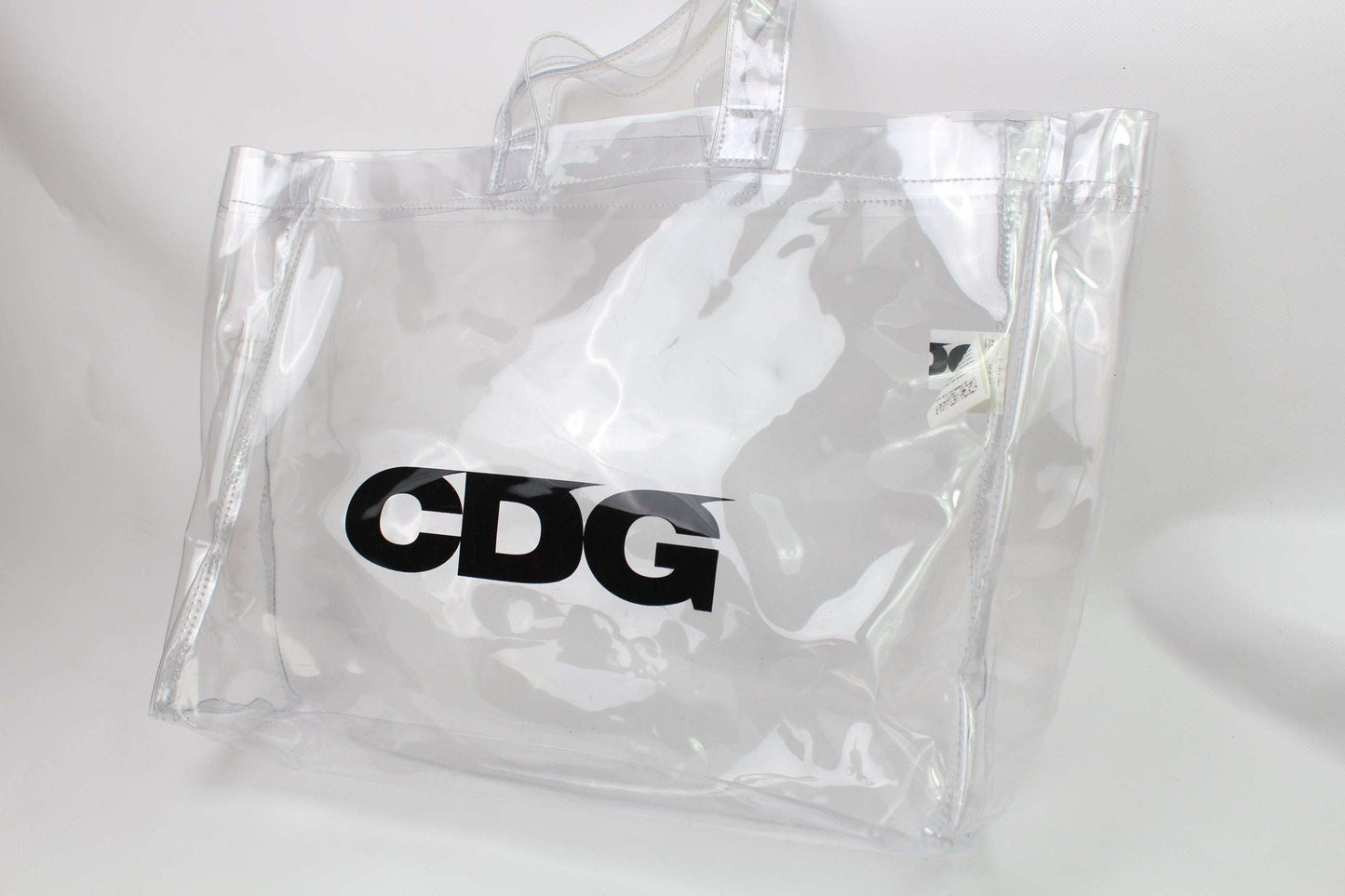 Clear COMME DES GARCONS shopper bag made of plastic, condition 9/10 with light wear marks.
