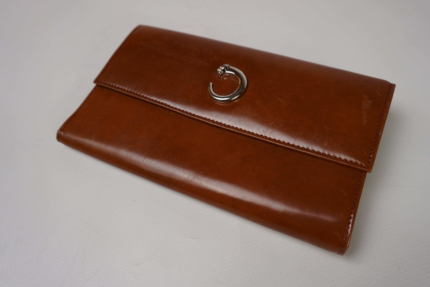 Cartier leather longwallet in brown with silver clasp, size 21x10cm.