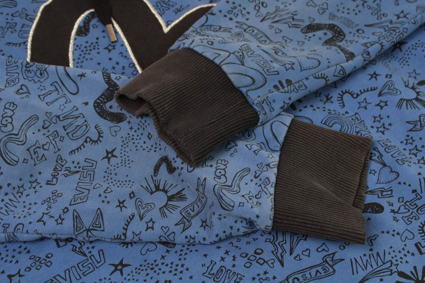 EVISU Hoodie Blue with pattern details and dark ribbed cuffs.