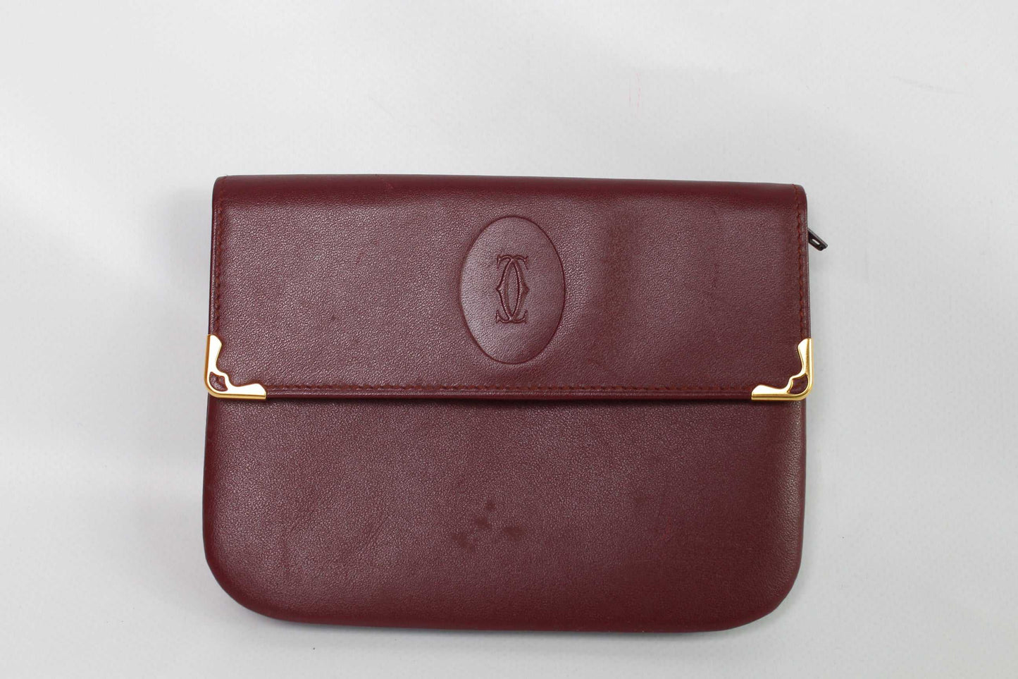CARTIER Leather Longwallet Bordeaux, red leather, 15x10 cm, gold accents.