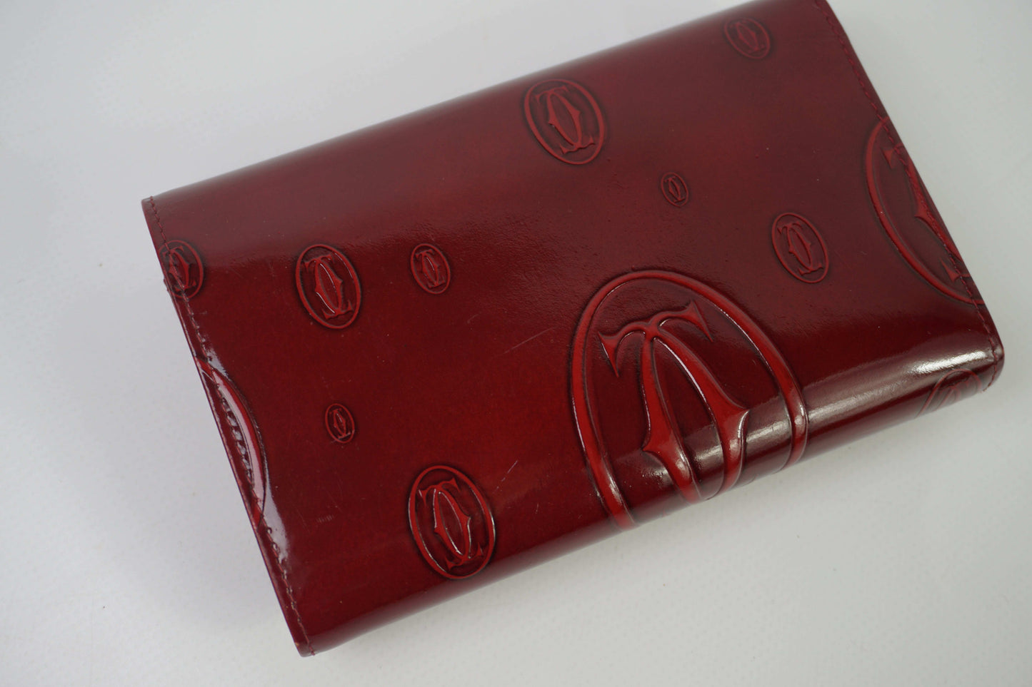 CARTIER Leather Longwallet Bordeaux in red, size 18x13cm, excellent condition.