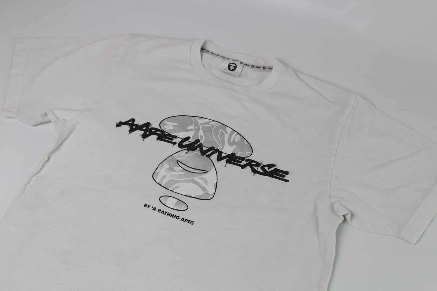 BAPE AAPE Laser Foil Camo Stencil Face TeeBAPE AAPE Laser Foil Camo Stencil Face Tee | LAYZSSHOP | Bape