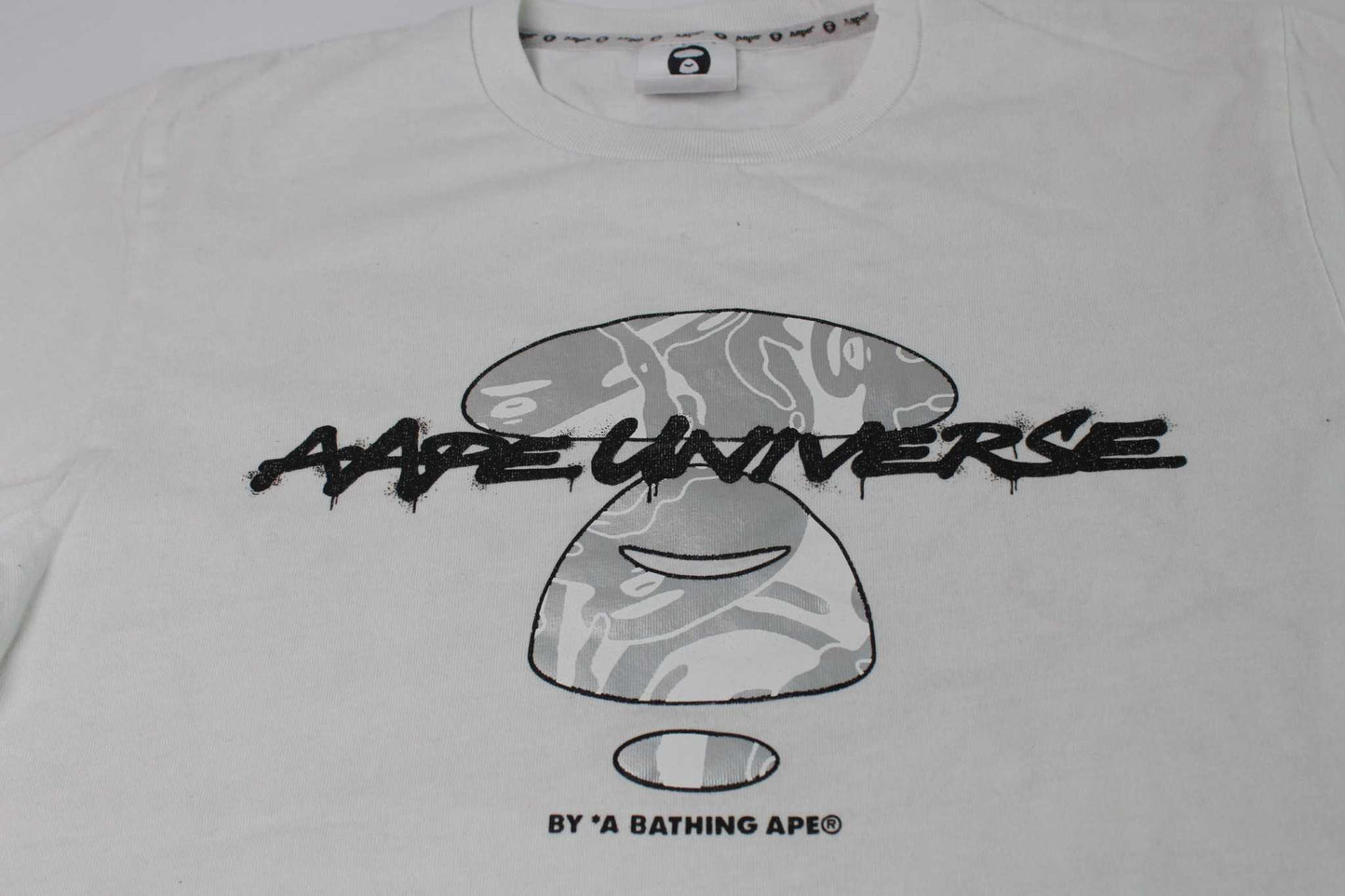 BAPE AAPE Laser Foil Camo Stencil Face TeeBAPE AAPE Laser Foil Camo Stencil Face Tee | LAYZSSHOP | Bape