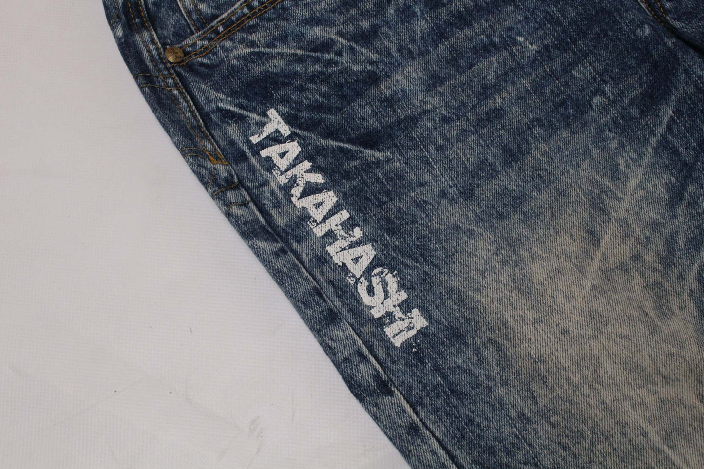 Blue denim jeans with "TAKAHASHI" embroidery detail, BIG TRAIN Embroidery Tiger style.