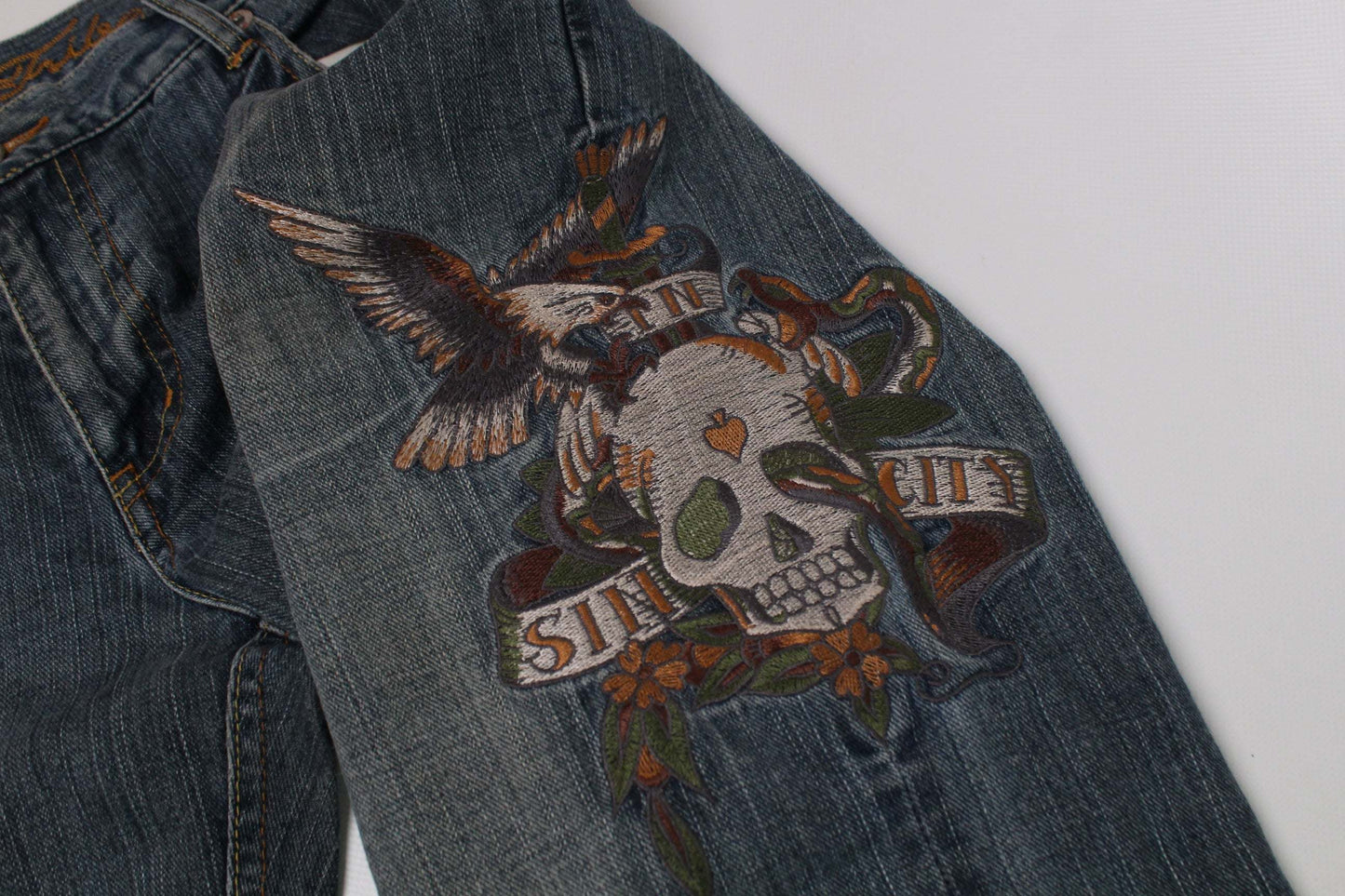 Blue Urban Fiber embroidery denim jeans with skull and eagle design, baggy fit, size 4, 100% cotton.