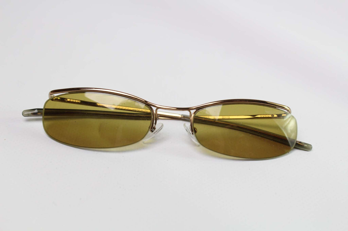 GUCCI Shades Yellow sunglasses with yellow lenses on a white background.