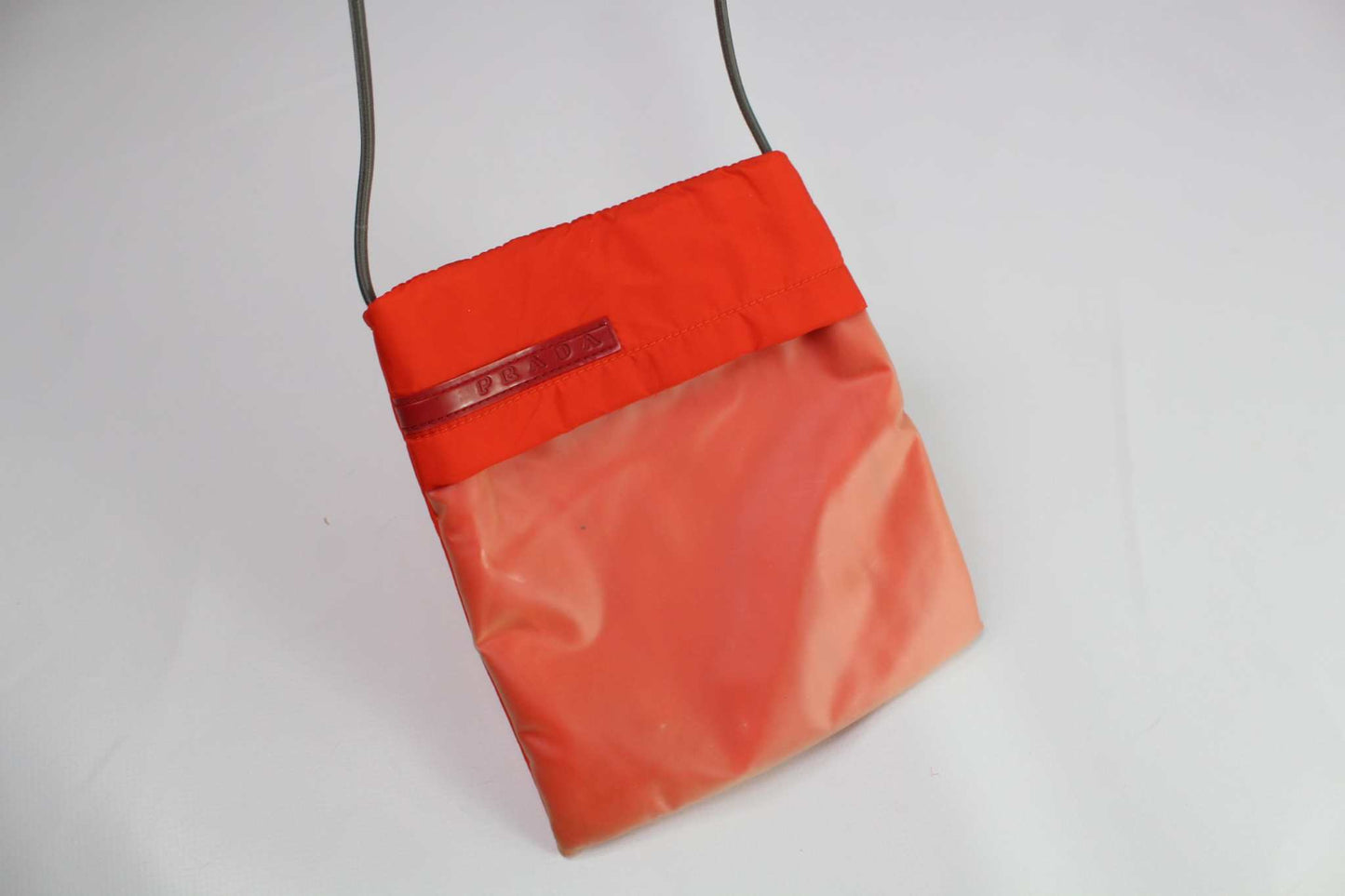 PRADA Sports Slingbag Orange, 20x17 cm, nylon material, elastic rubber straps.