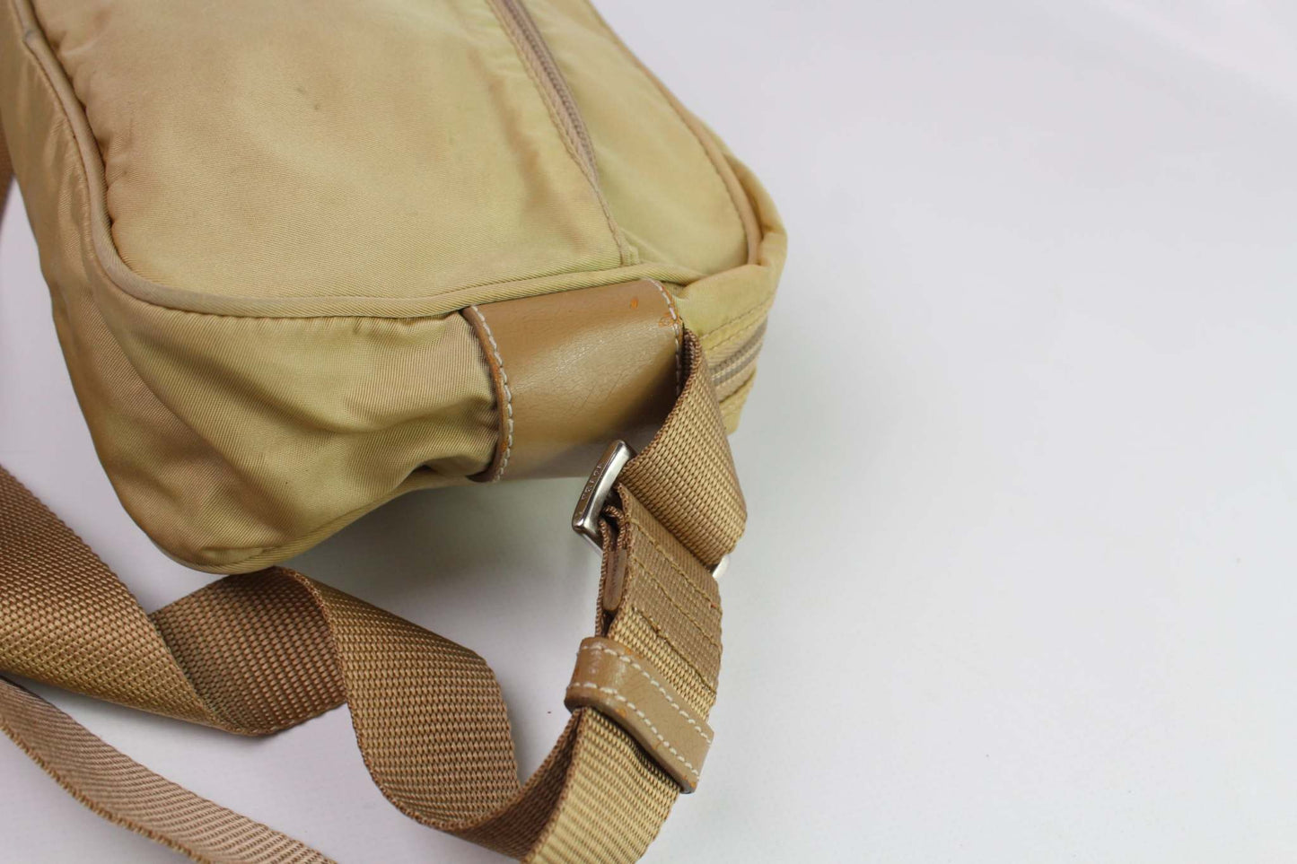 Beige PRADA crossbody bag with nylon material and adjustable strap.