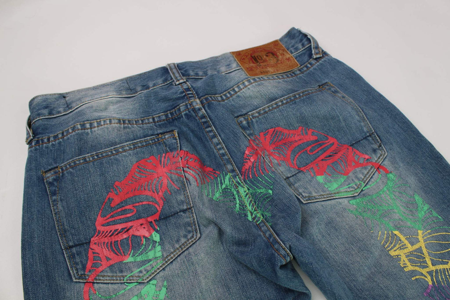 EVISU Rainbow Daicock Denim Pants in dark blue with orange and blue detailing, size 34x33, baggy fit.
