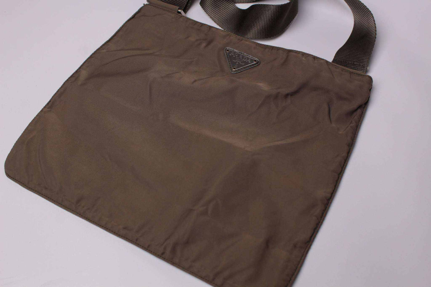 Brown PRADA slingbag made of nylon, size 25x25cm, condition 8/10.