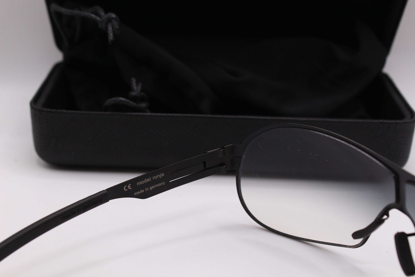 IC! berlin Shades model ronja in black with case in background.