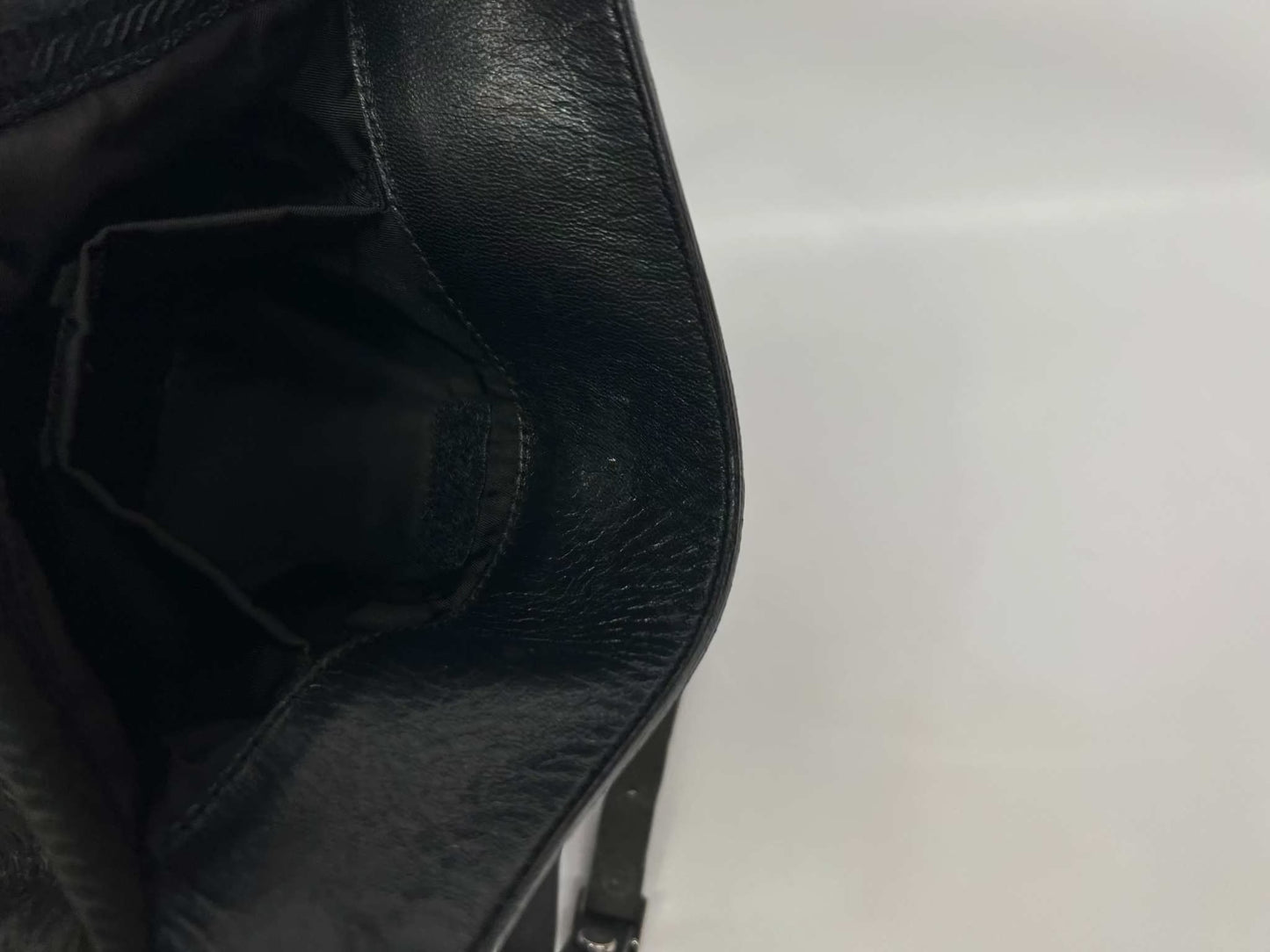 Black PRADA slingbag, 20x20 cm, nylon material, interior view.