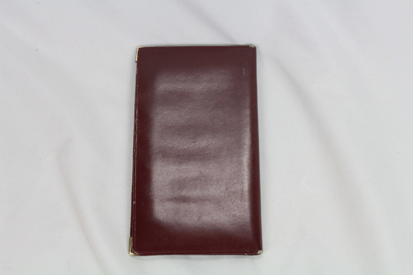 Brown Cartier wallet in good condition on a white background.