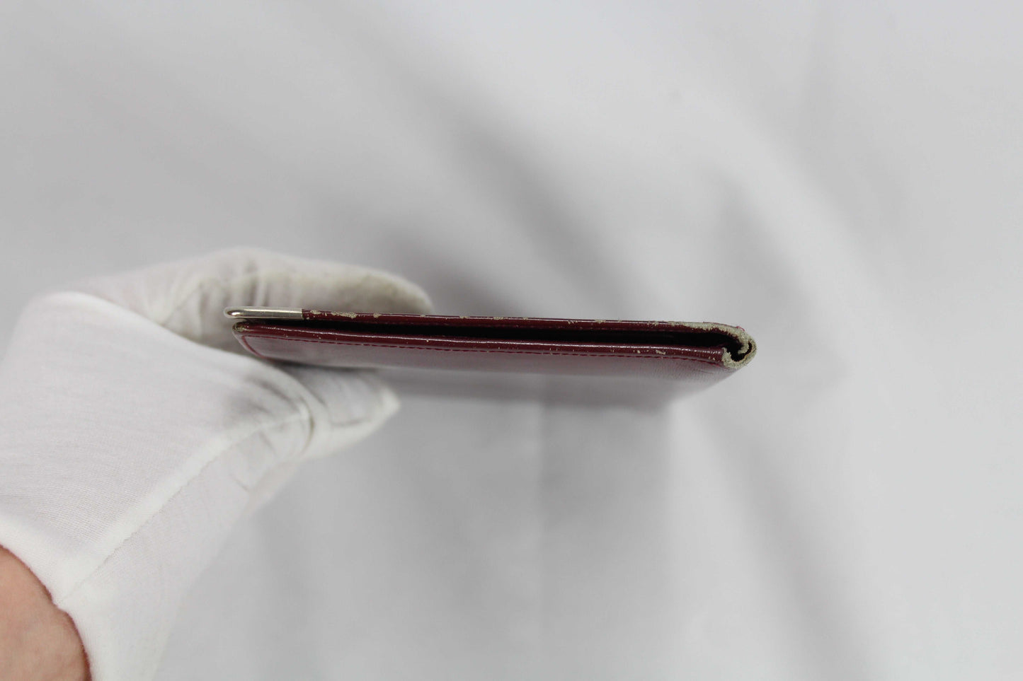 Cartier Wallet in good condition, side view.