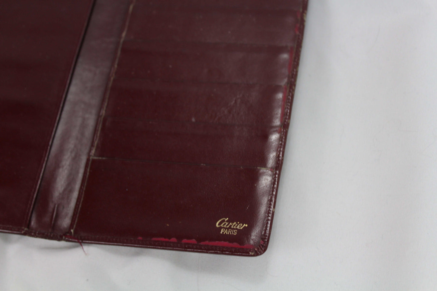 Cartier wallet in good condition displaying interior slots.