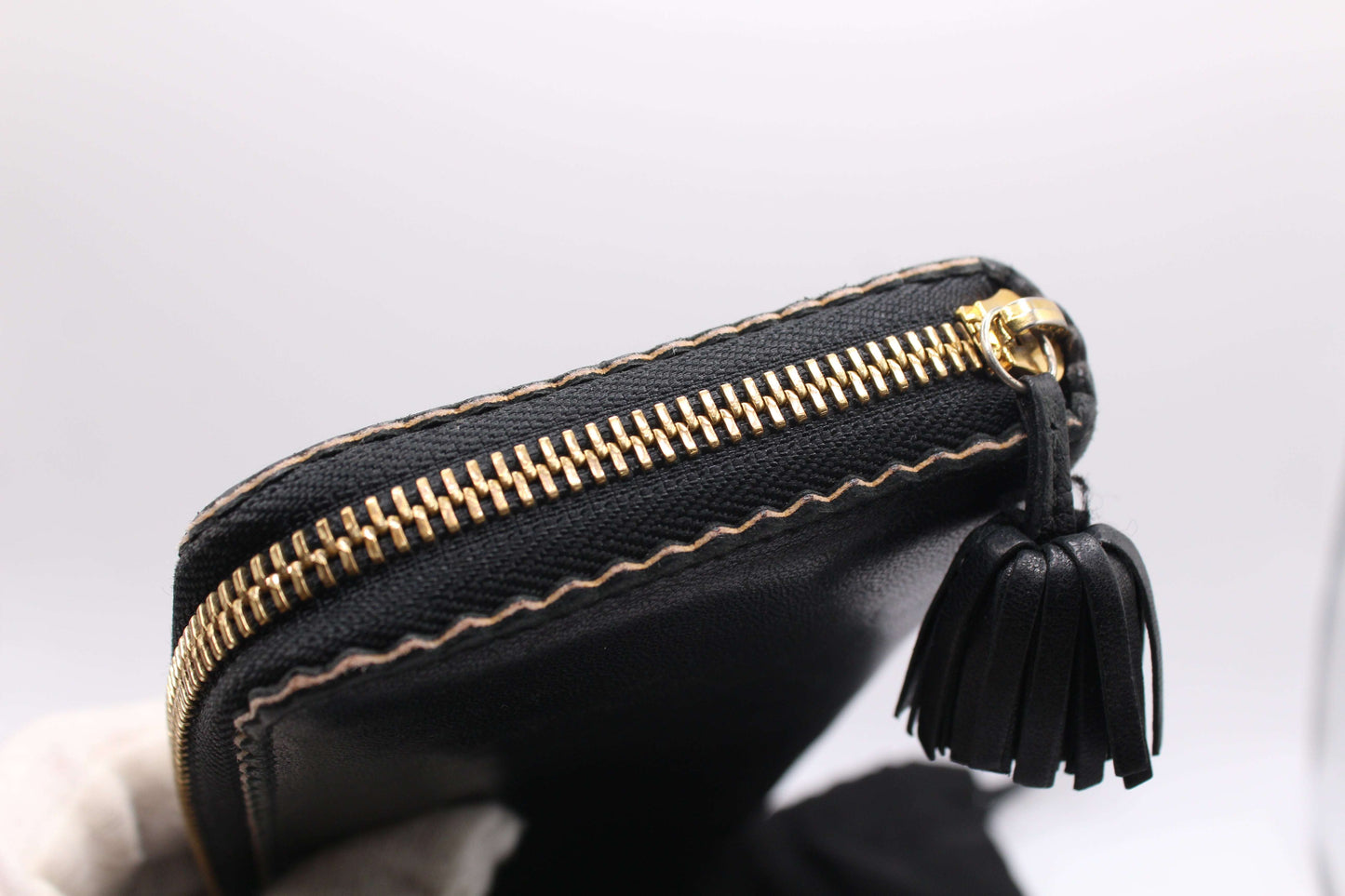 Black Loewe Long Wallet in leather with gold zipper detailing and tassel, size 20x10 cm.