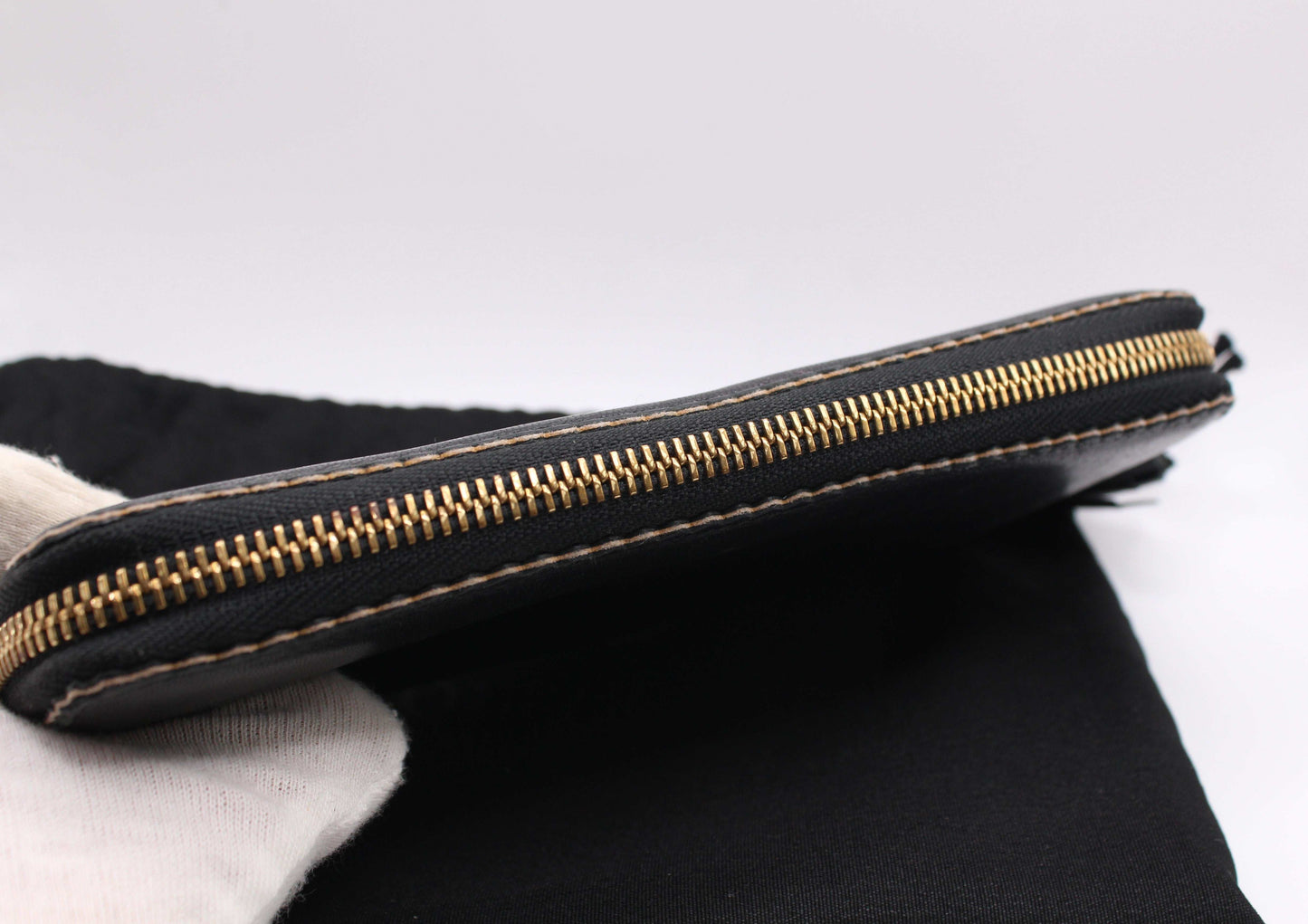 Black Loewe Long Wallet in leather with slight wear, size 20x10 cm, featuring a zipper, includes dustbag and material card.