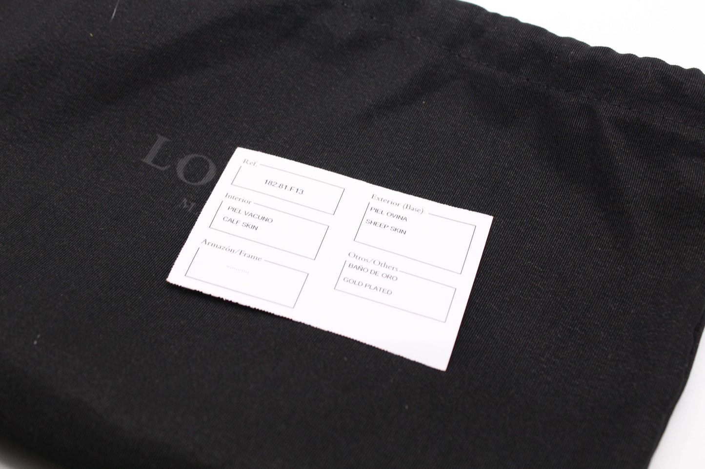 Black Loewe long wallet with dustbag and material card, size 20x10 cm, leather material, minor wear.