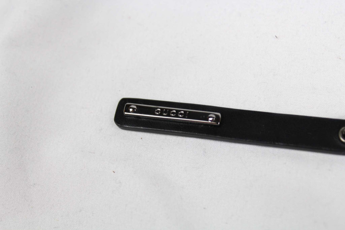Gucci keychain in good condition with black and silver design.