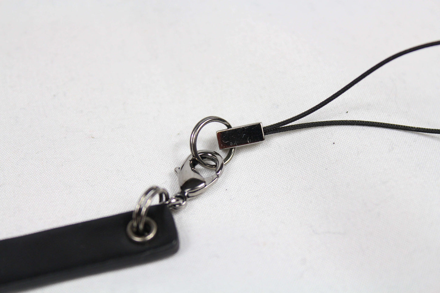 Gucci keychain in good condition with black strap and metal clip.