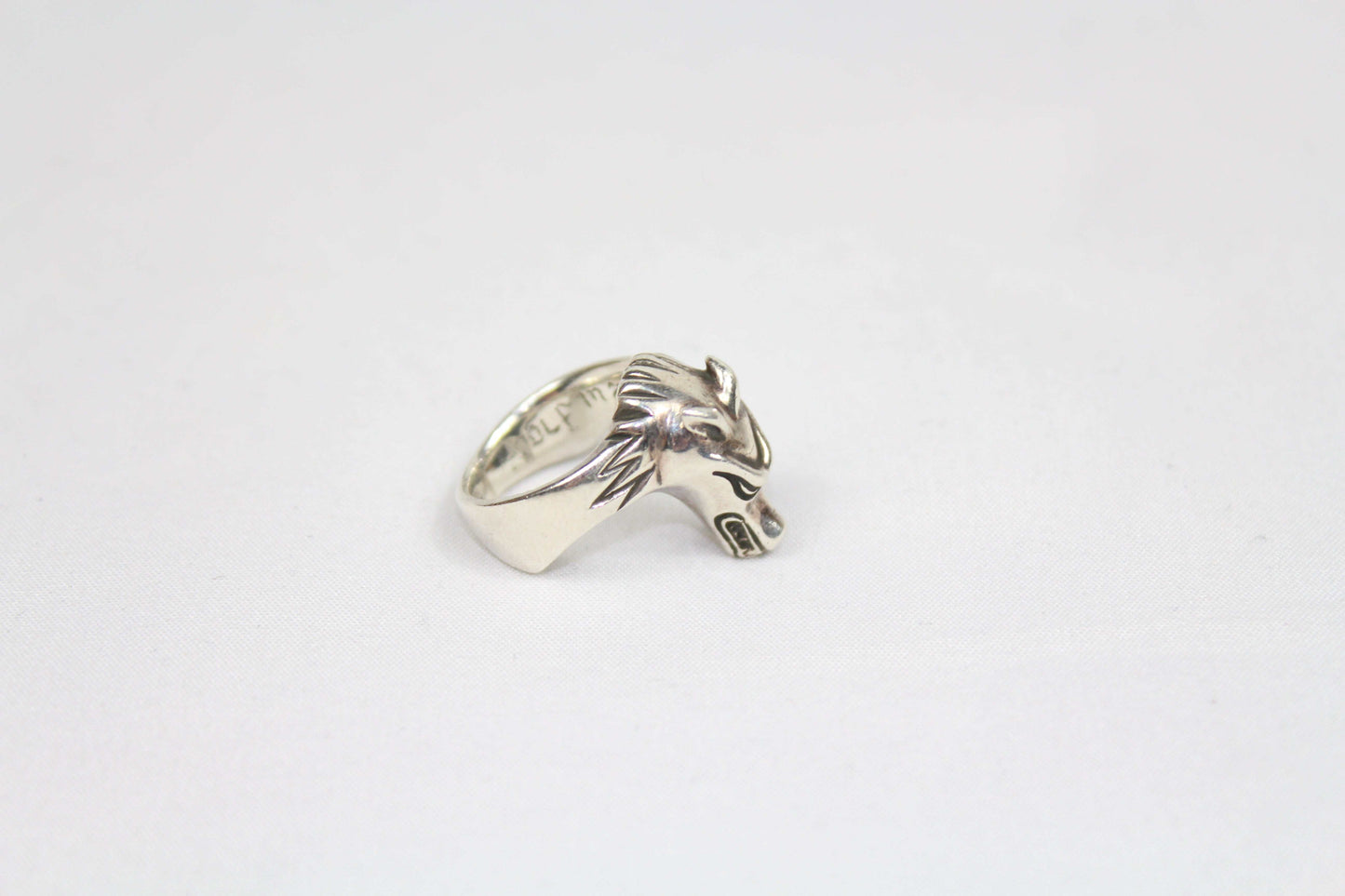 Silver ring with wolf design, size 16mm, in good condition.