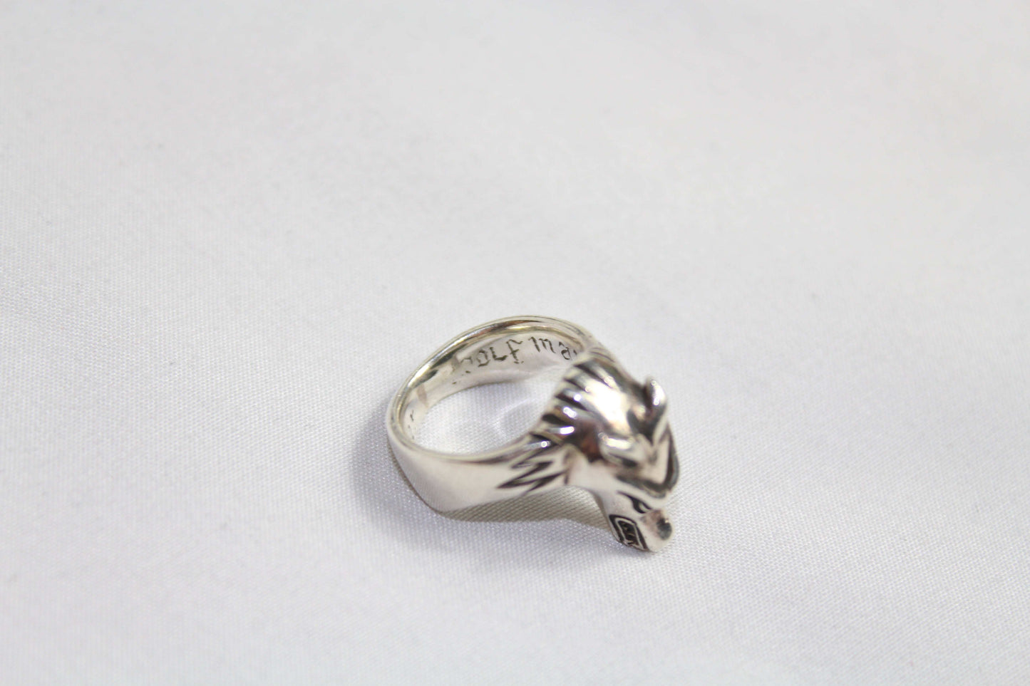 Silver ring with wolf design, size 16mm, in good condition.
