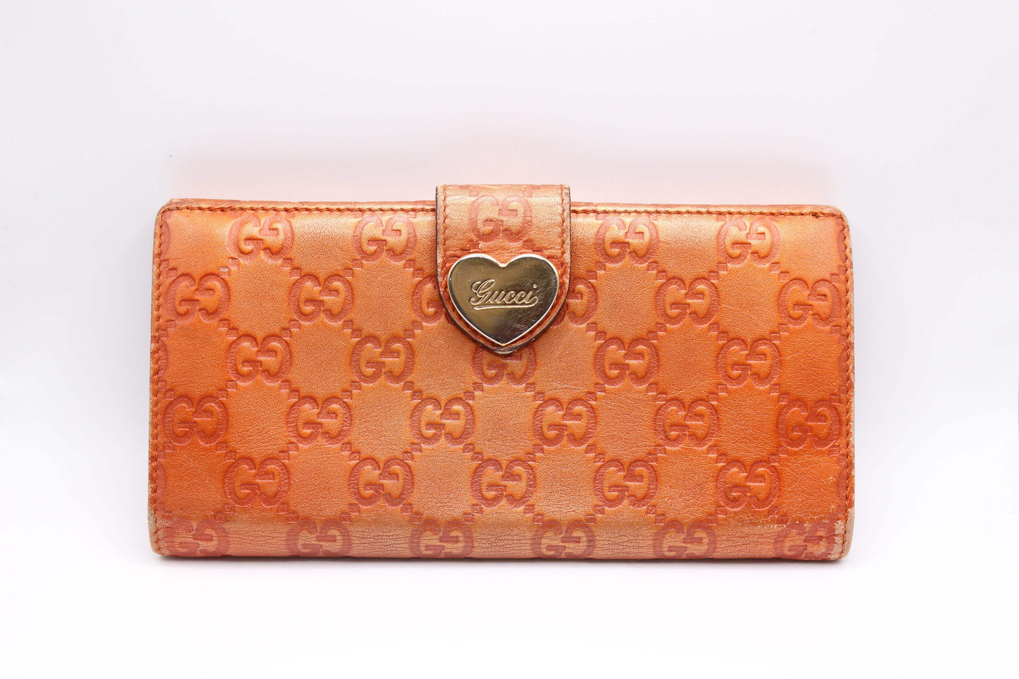 GUCCI longwallet in orange leather with embossed logo pattern, 20x10 cm, condition 7/10.