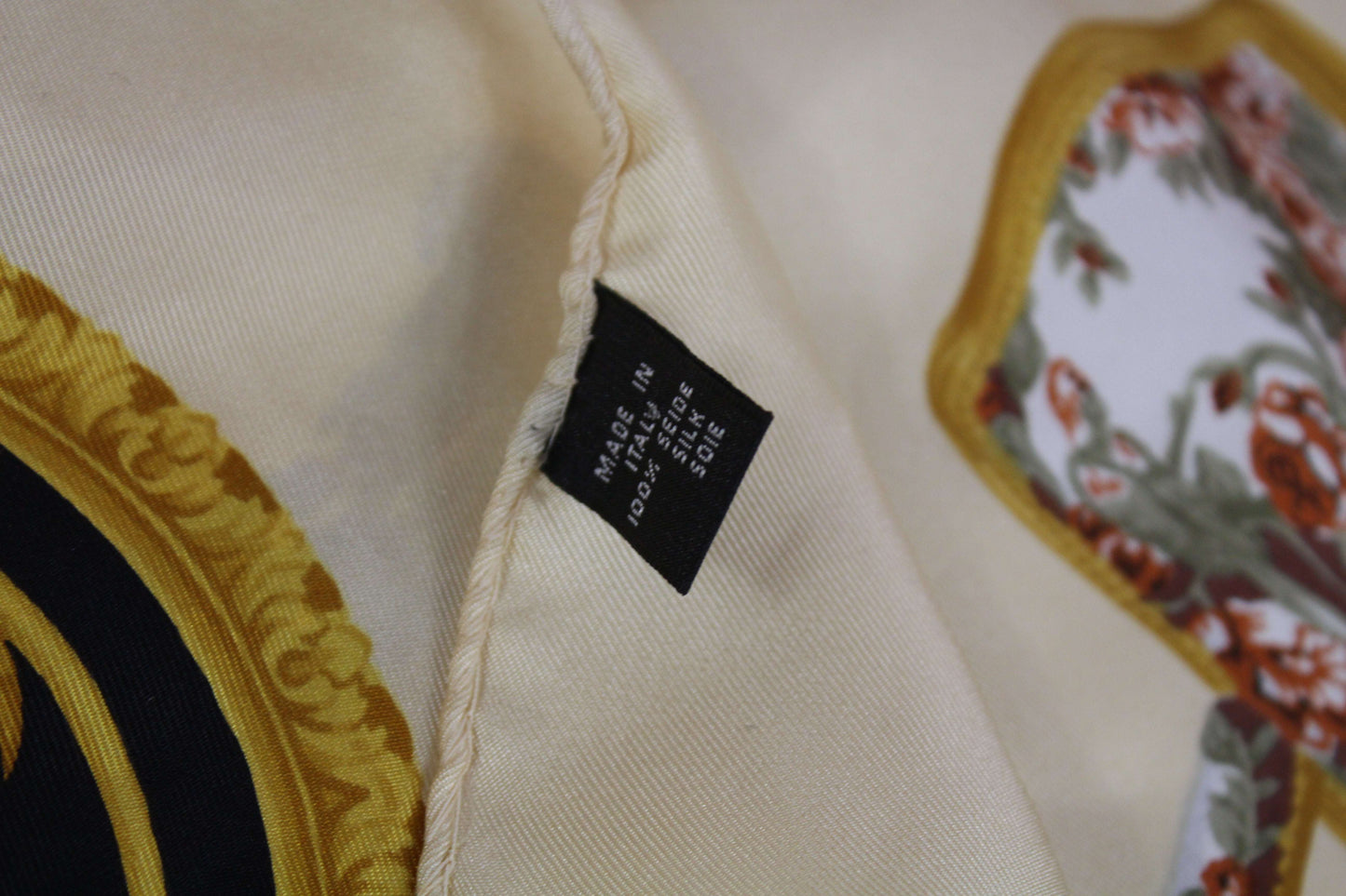 LANCEL Silk Scarf Gold with floral design and black label, 100% silk fabric.