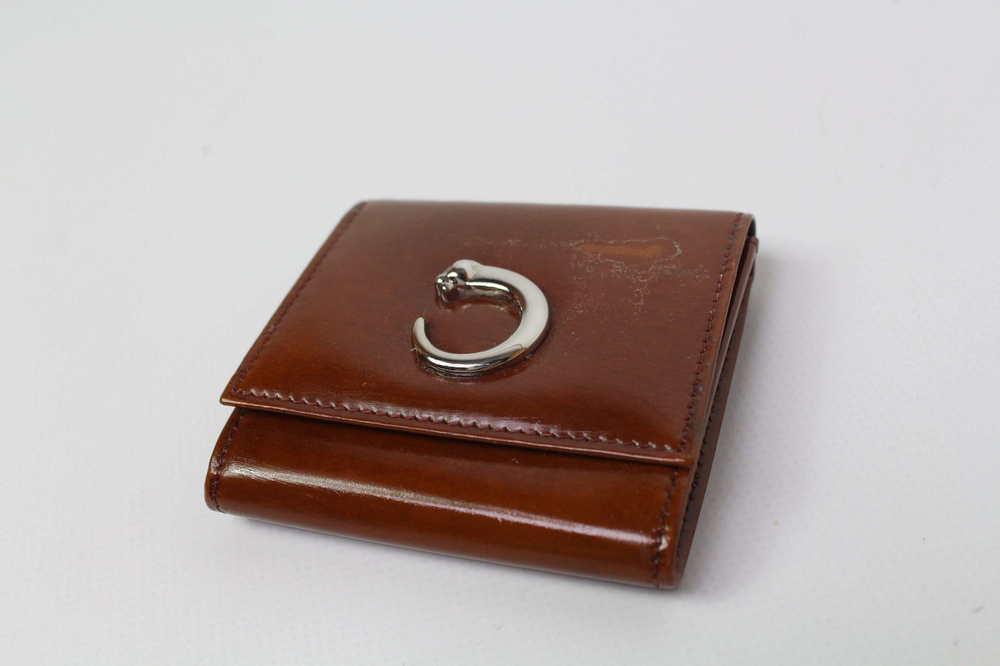 Cartier Portmonee Orange leather wallet with silver clasp, size 8x8cm, condition 7/10.