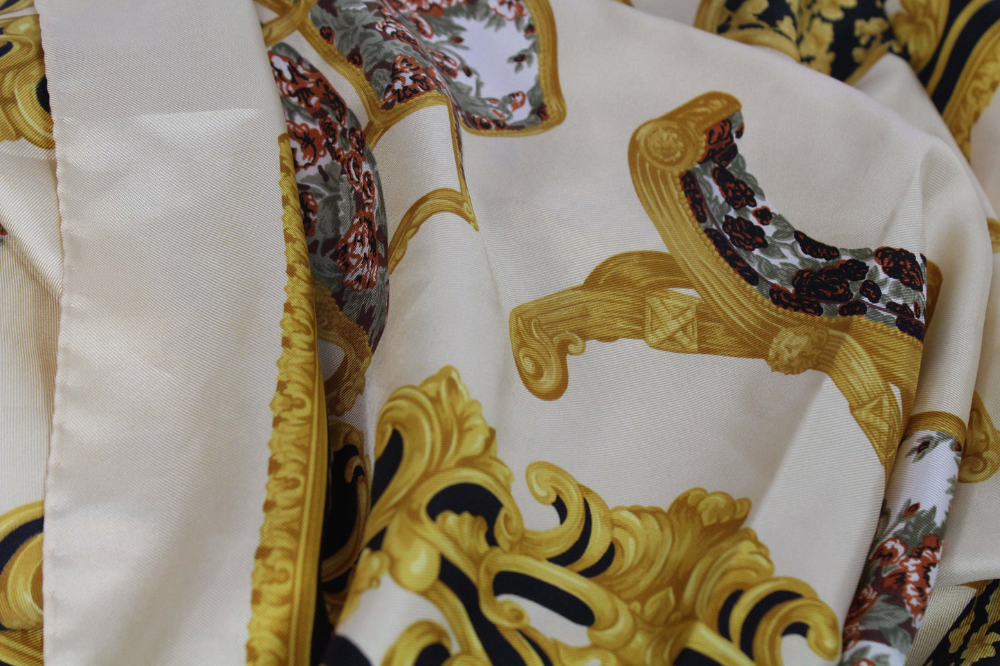 LANCEL Silk Scarf Gold with ornate gold patterns and floral details on luxurious silk fabric.