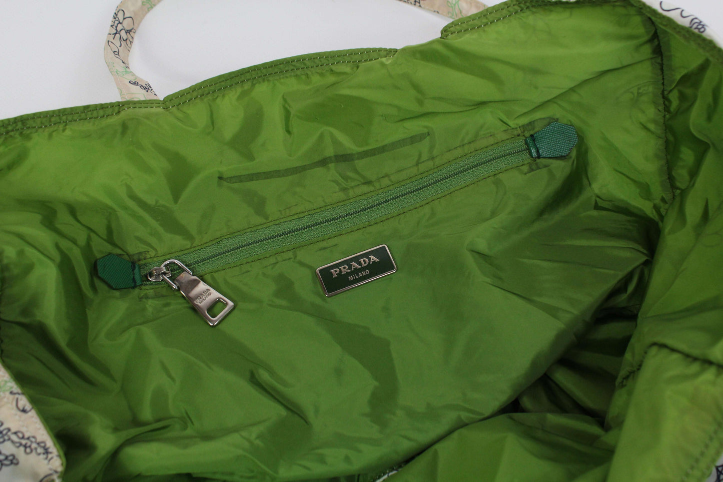 PRADA Shopper in green and white with flower design and green interior.