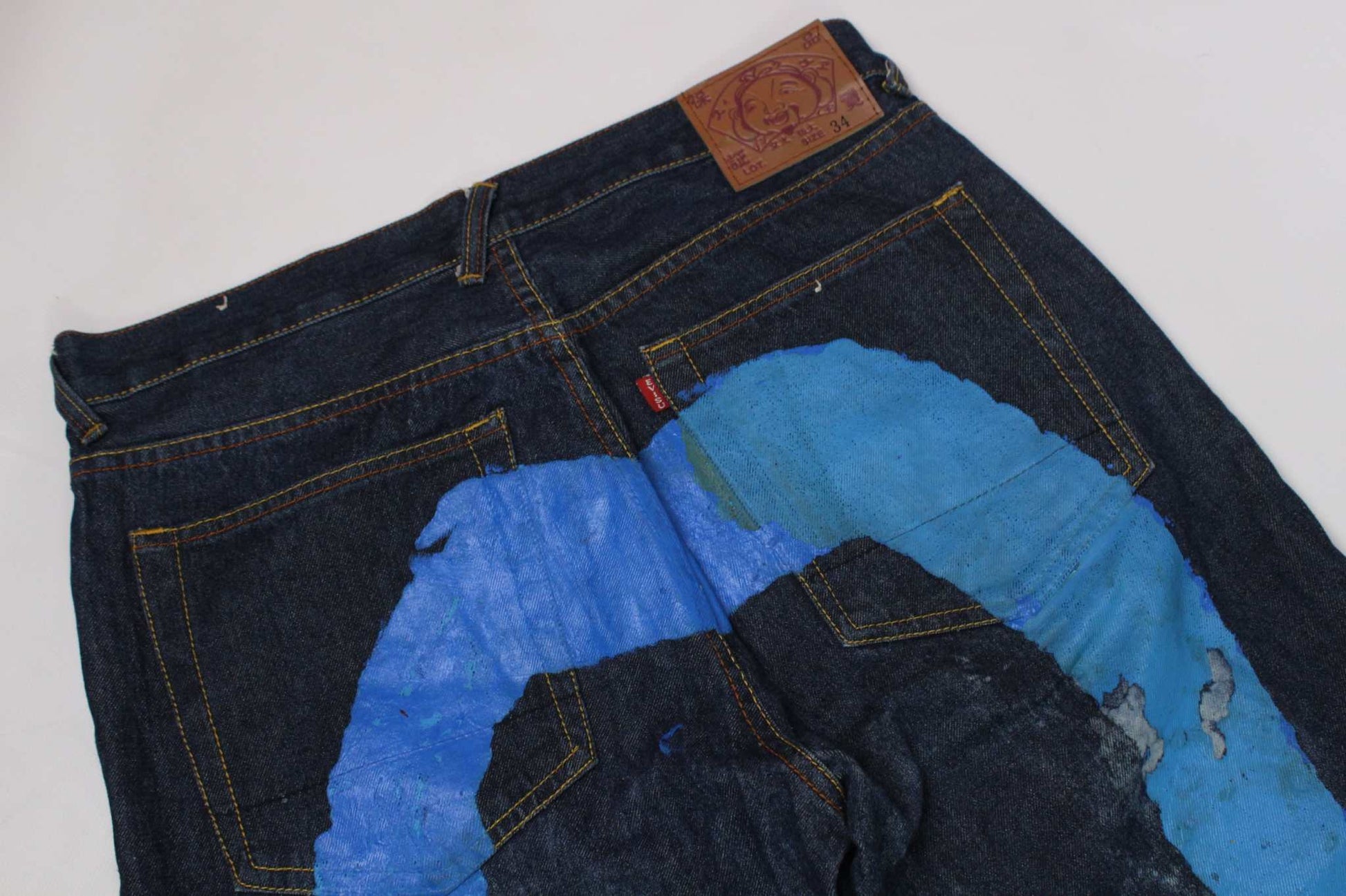 EVISU Blue Paint Daicock Denim jeans with blue paint details on the back, baggy fit.