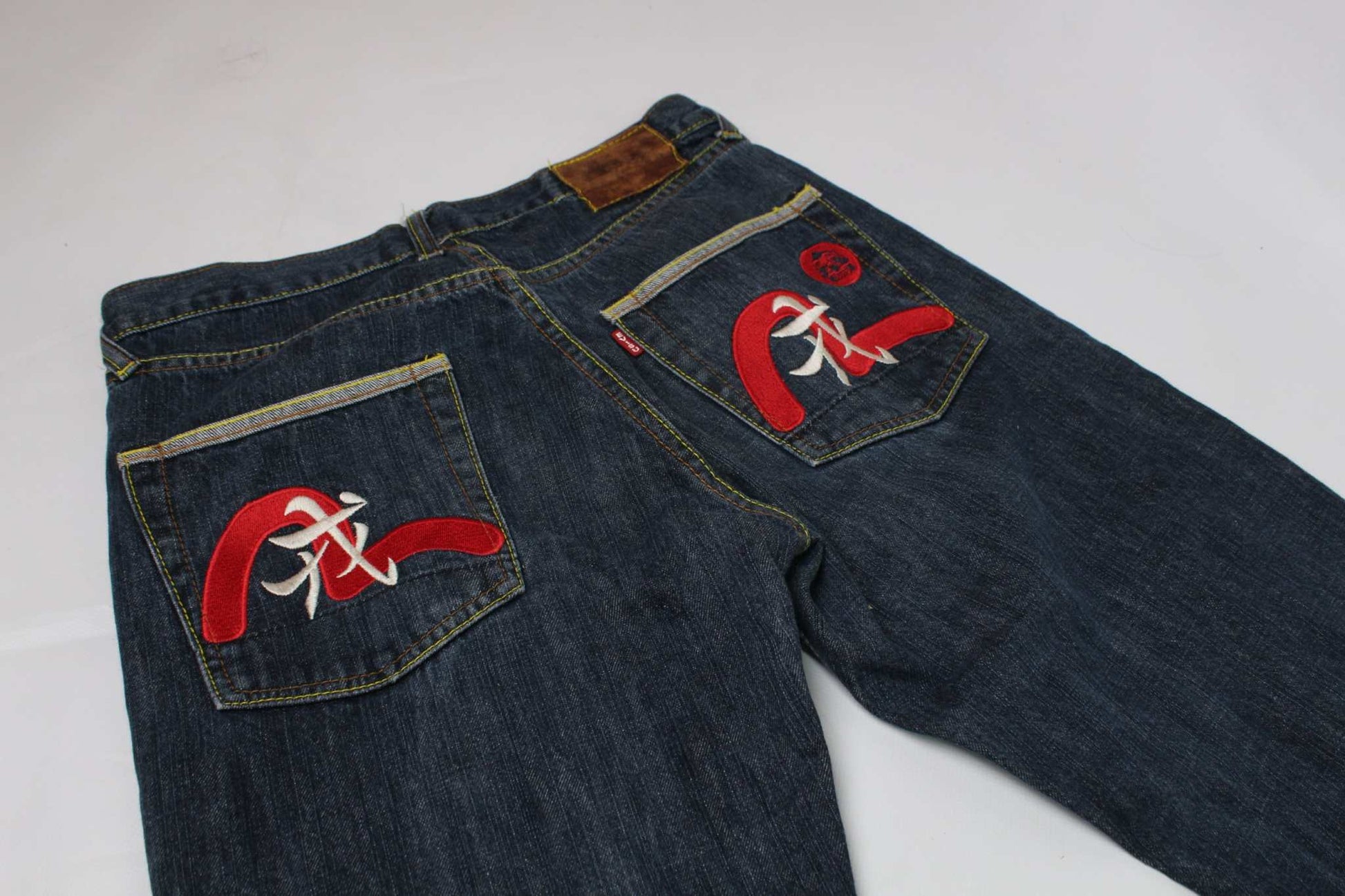 EVISU Japanese denim jeans with red accents and straight fit.