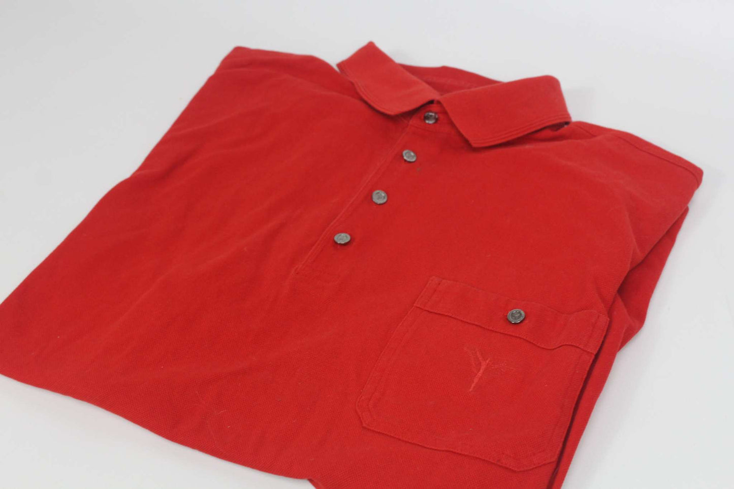 Carlo Colucci red shirt with buttons and pocket, folded.