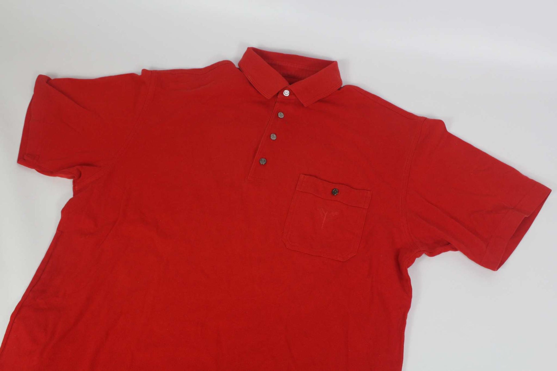 Carlo Colucci red short-sleeve shirt with button-up collar and chest pocket.