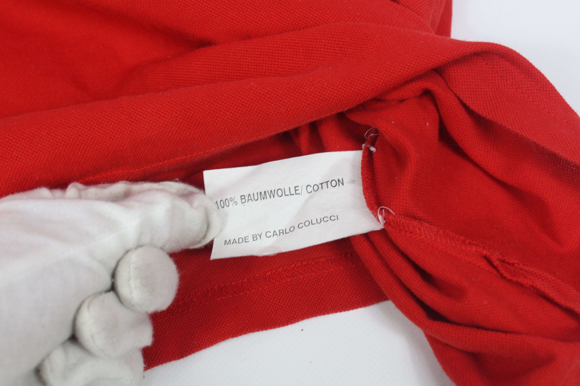 Carlo Colucci red cotton shirt label showing 100% Baumwolle.