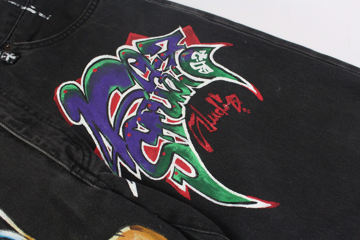 Edwin denim with custom hand-painted graffiti design, black/grey color, straight fit.