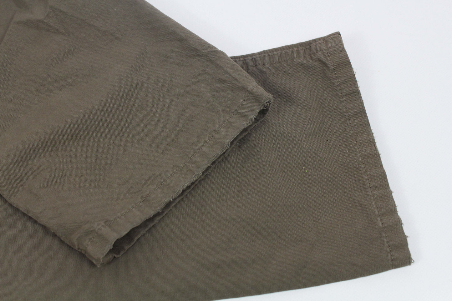 Dolce & Gabbana pants in gray-green color showing fabric detail.