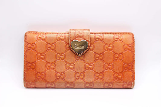 GUCCI longwallet in orange leather with embossed logo pattern, 20x10 cm, condition 7/10.