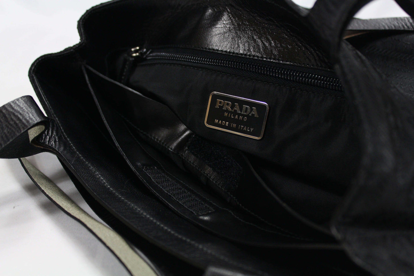 Prada Shopper Inside-Out handbag interior with label, showing slight handle flaw.