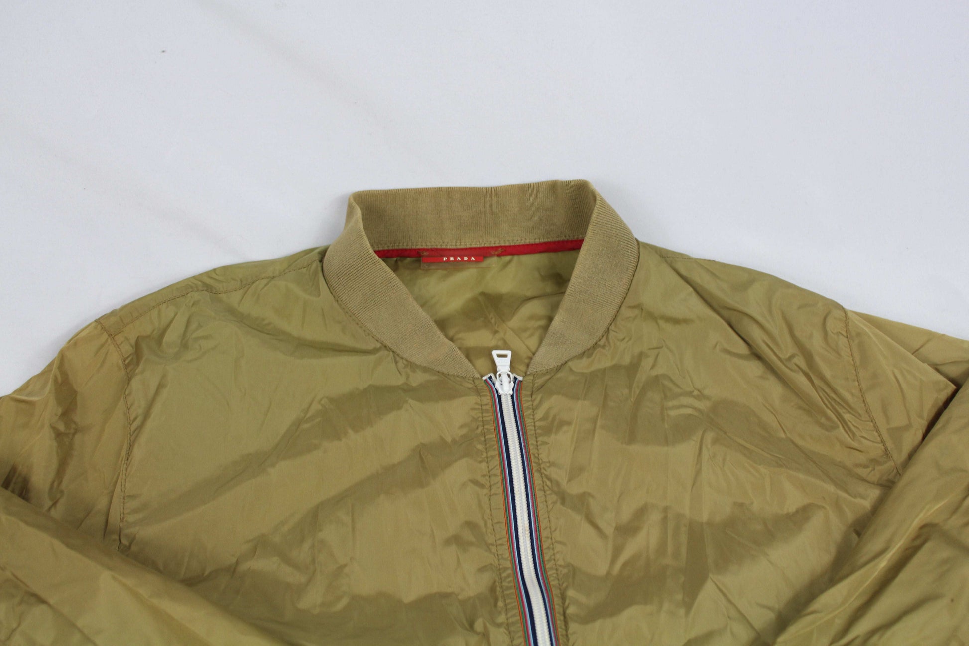 Prada Windbreaker, size S-M, beige with zip closure, in good condition, 100% nylon.